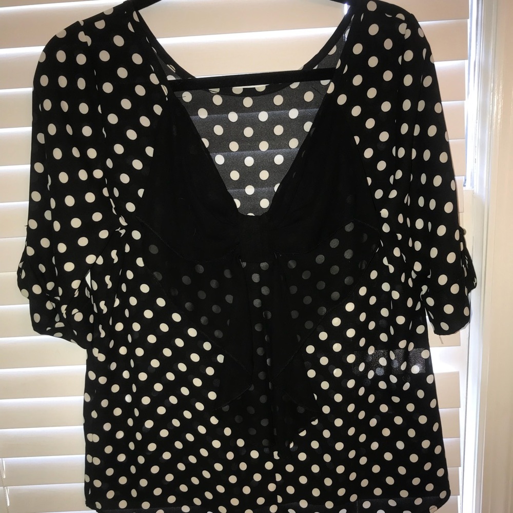 Adorable polka dot shirt with a bow on the back!